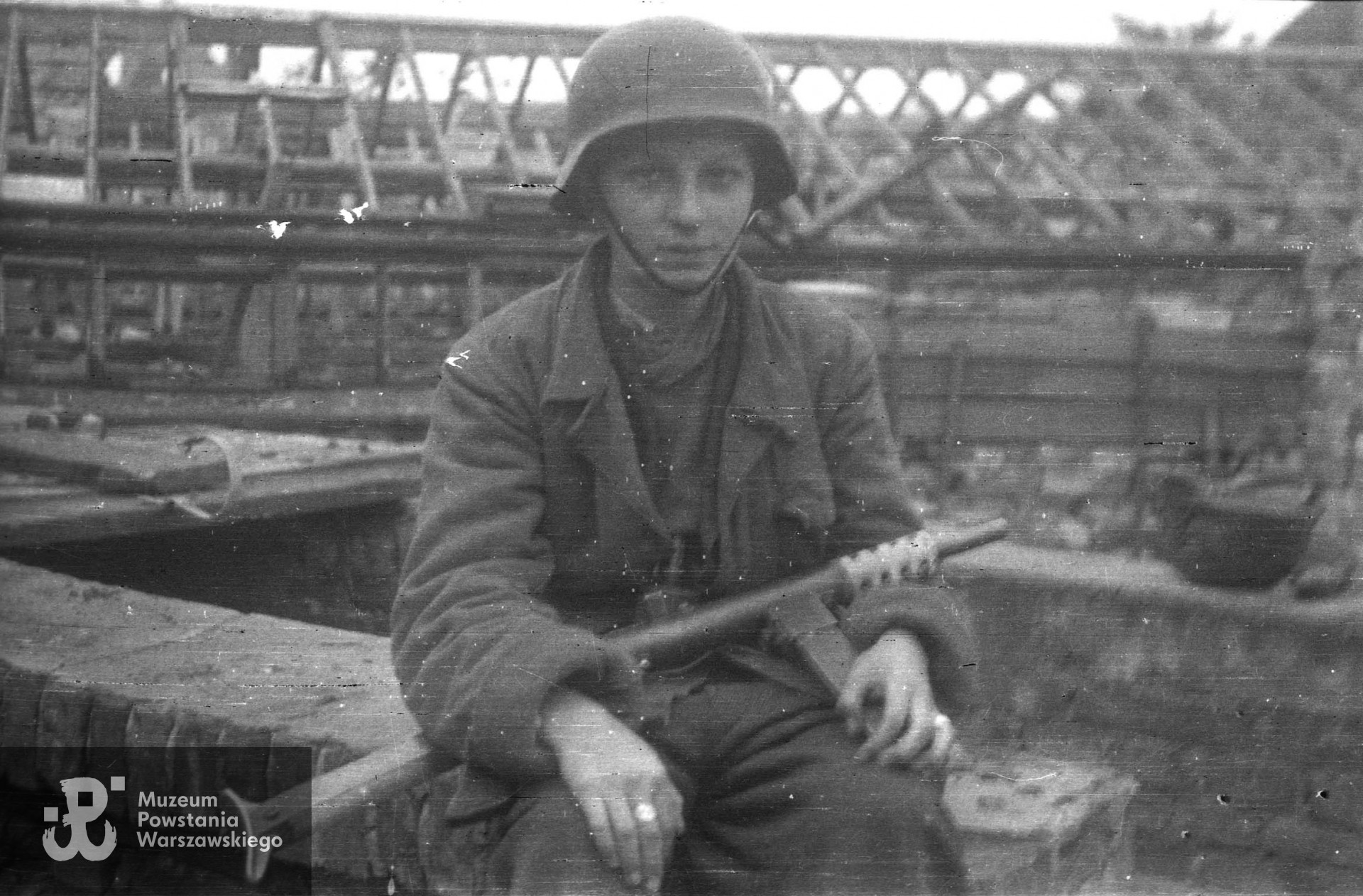 Fotografia z Powstania Warszawskiego, koniec września 1944 r.  Strz. Tadeusz Rajszczak "Maszynka" z Batalionu "Miotła" pluton "Torpedy" w ogrodach Instytutu Głuchoniemych i Ociemniałych przy placu Trzech Krzyży. Autorem zdjęcia jest Jerzy Michalski "Korczak". Fot. ze zbiorów Muzeum Powstania Warszawskiego, sygn. MPW-IN/4246 (P/4999/06). 