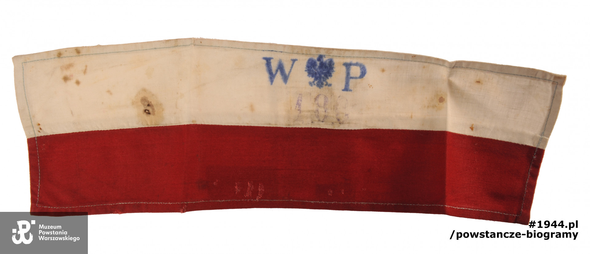 Opaska powstańcza należąca do Krystyny Friedwald ps. "Mewa" "Krysia". Ze zbiorów Muzeum Powstania Warszawskiego, sygn.  P/4625 - M/708.