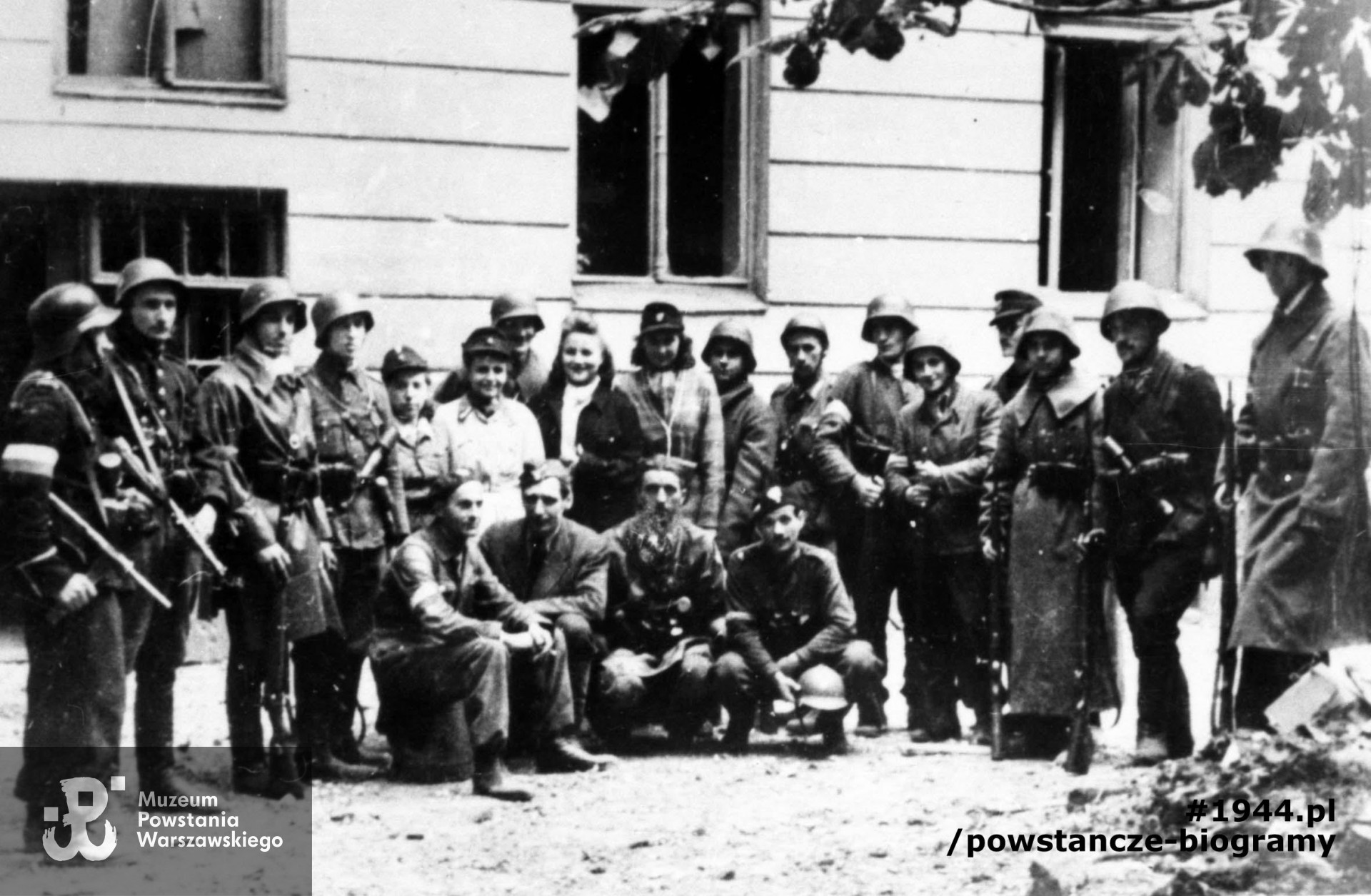 6-7 pażdziernika 1944 r. Grupa żołnierzy plut. NSZ "Sikora" kompanii "A" batalionu osłonowego AK przed kamienicą w Śródmieściu Południowym. Stoją: plut. pchor. Jan Podhorski "Zygzak" - siódmy od lewej, kpr. Włodzimierz Jakimowicz "Szczapa" - dziesiaty od lewej, kpr. pchor. Henryk Dutkowski "Kosowski" - czwarty od prawej. Klęczą od lewej: zbrojmistrz Józef Krynojewski, NN, ppor. Henryk Czapczyk "Mirski", "Śmigły" Pałaszewski. Autorem zdjęcia jest Henryk Świercz "Świerszcz". Fot. ze zbiorów Muzeum Powstania Warszawskiego, sygn. MPW-IN/3536