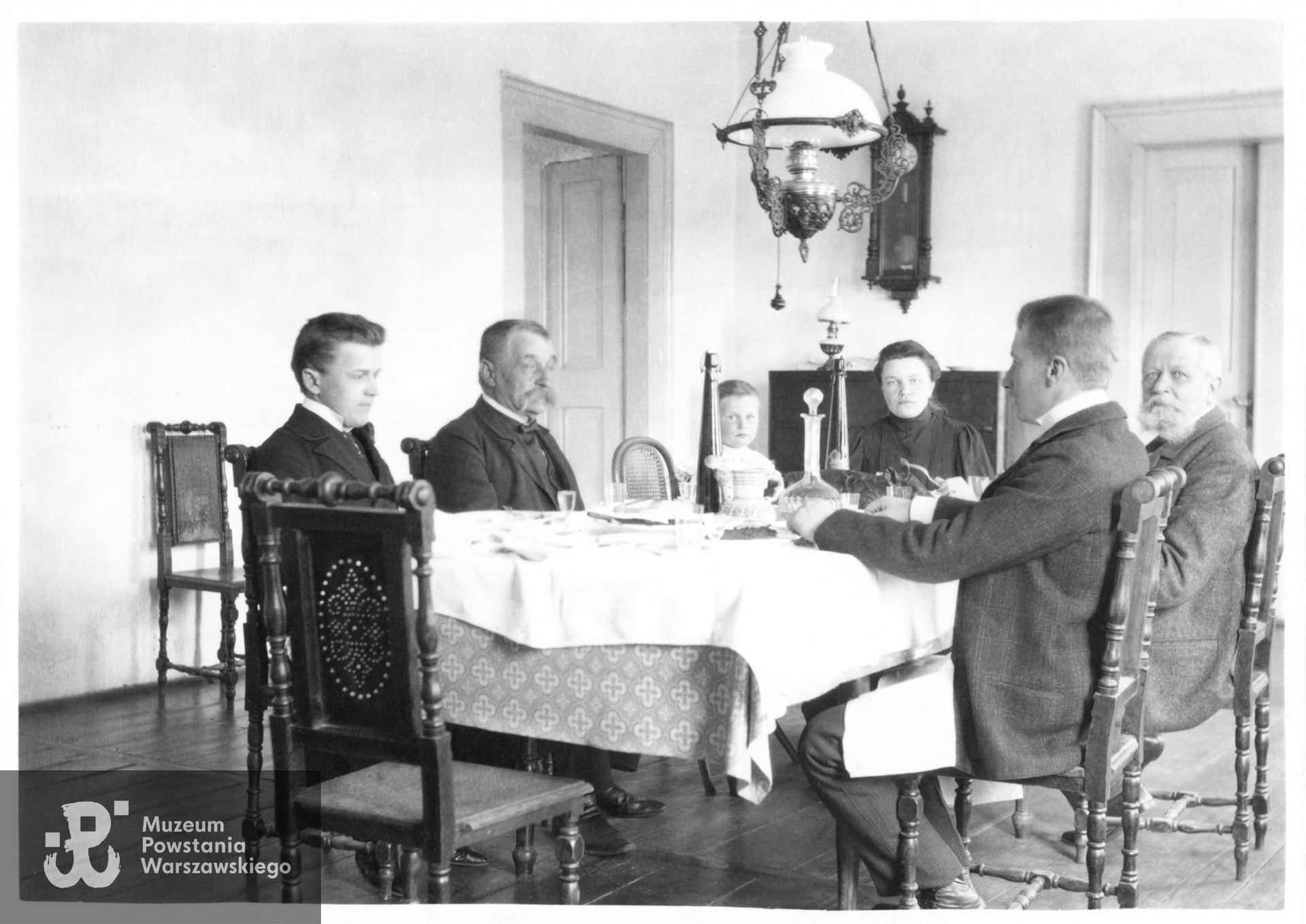 Zdjęcie wykonane ok. 1905 roku. Sala jadalna w majątku rodzinnym w Hołuzji na Wołyniu, po prawej z brodą "przyszywany dziadek" Marian Konopacki, w środku Konstancja z Zaleskich Konopacka - matka Ireny i mała Irena. Fot. z archiwum rodziny Semadenich, do wykonania kopii udostępnił p. Zbigniew Semadeni.