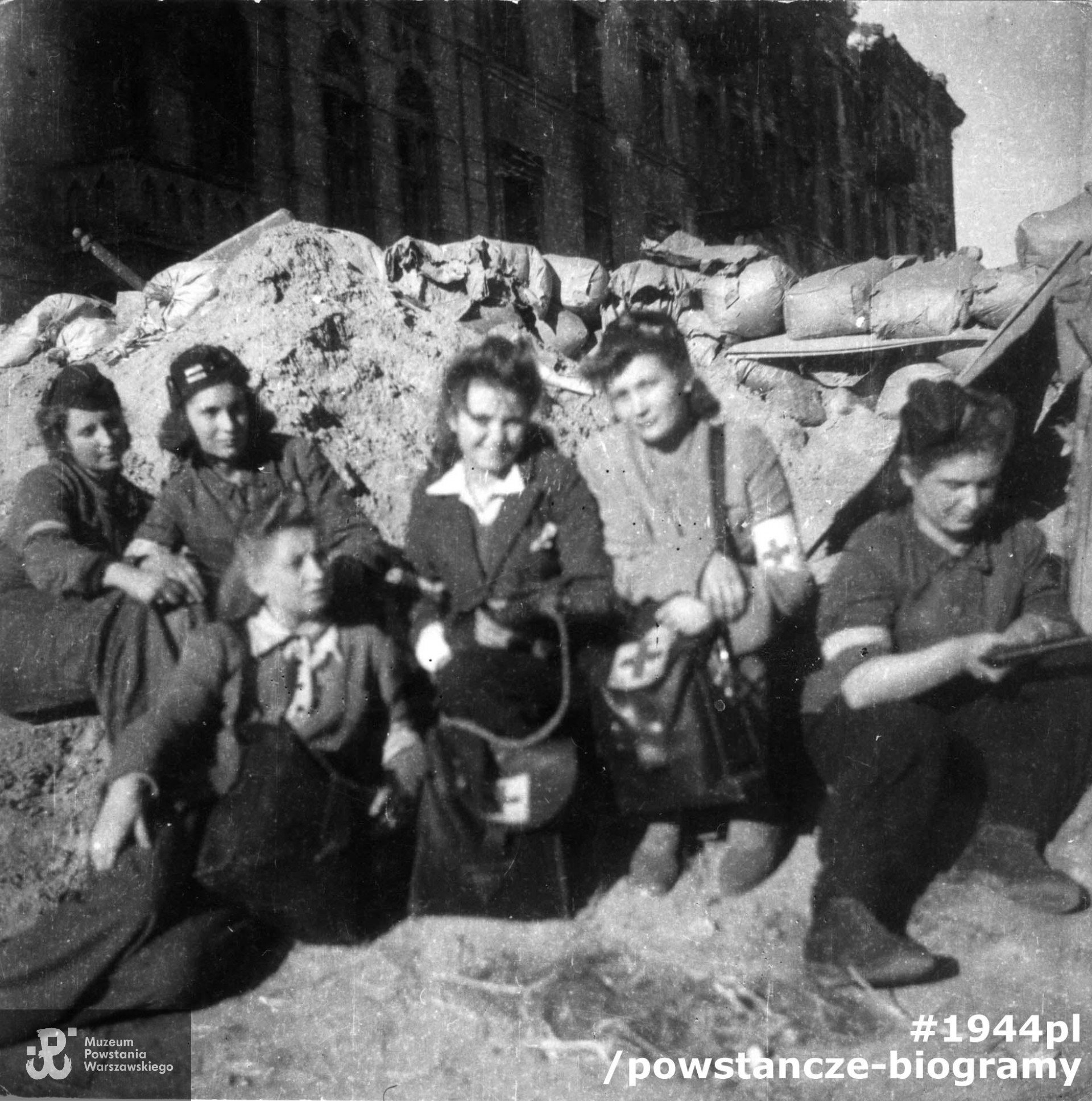 Sanitariuszki z 3 plutonu kompanii szturmowej batalionu "Kiliński" przy barykadzie na wysokości budynku Grzybowska 6. Od prawej: Jadwiga Włodarska "Jadzia", Krystyna Świder "Lena", Krystyna Borysławska " Maria Jolanta", patrolowa Halina Szulakowska "Irma", łączn. Aleksandra Zaborowska "Oleńka" poniżej: Maria Rosołowska "Ewa Mostowicz". Fotografia ze zbiorów Muzeum Powstania Warszawskiego sygnatura MPW-IP/2075