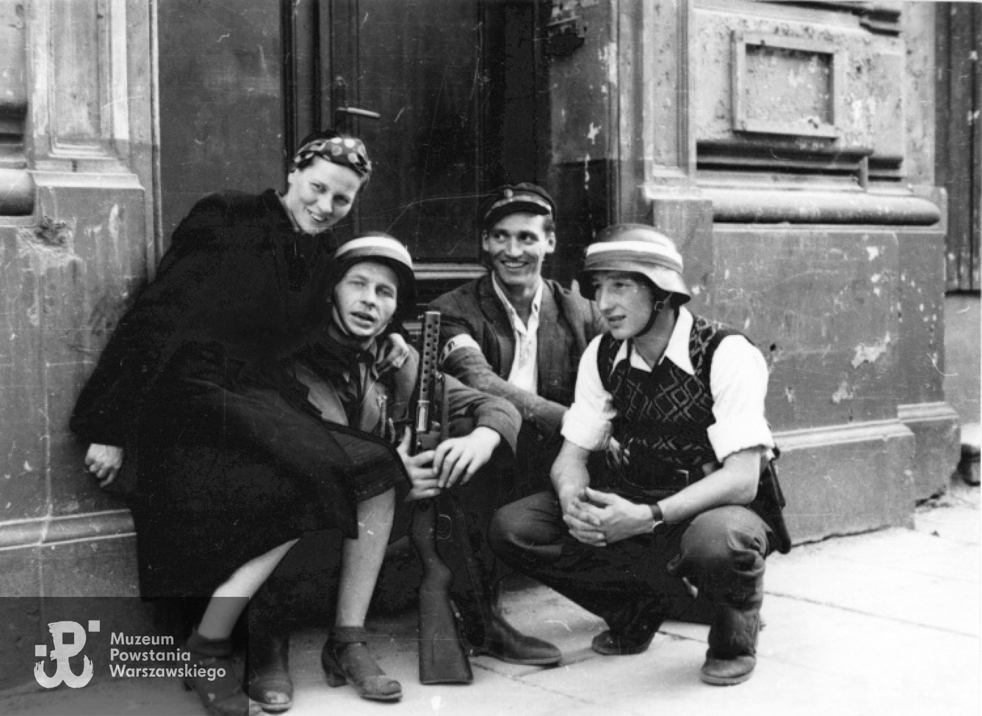 Od lewej: Zofia Domańska "Zocha" (siostra autora zdjęć), por. Roman Rozmiłowski "Zawada", trzymający niemiecki zdobyczny pistolet maszynowy MP 28 "Bergmann", ppor. Stanisław Kuśpit "Kruk" i kpr. pchor. Antoni Tuleja "Niedźwiedź". Fotografia autorstwa Eugeniusza Lokajskiego, zbiory MPW sygn. MPW-IN/43, prawa autorskie: MPW