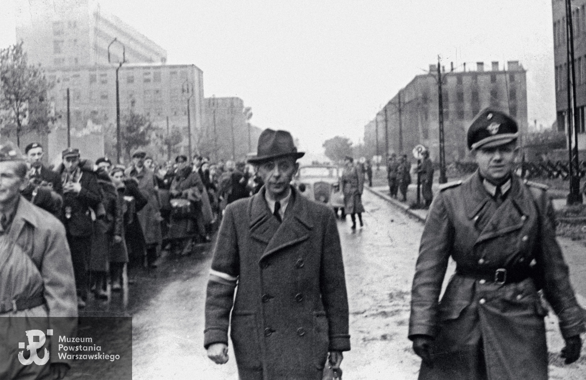 Warszawa po kapitulacji Powstania, w środku kadru na pierwszym planie widoczny gen. Tadeusz Komorowski "Bór".  Z lewej, postać w jasnym płaszczu (widać tylko połowę sylwetki) to według identyfikacji córki por. Anatol Dowgiałło-Chmorowicz.  Fot. udostępniła p. Bożenna Dowgiałło (Dowgiałło-Chmorowicz).