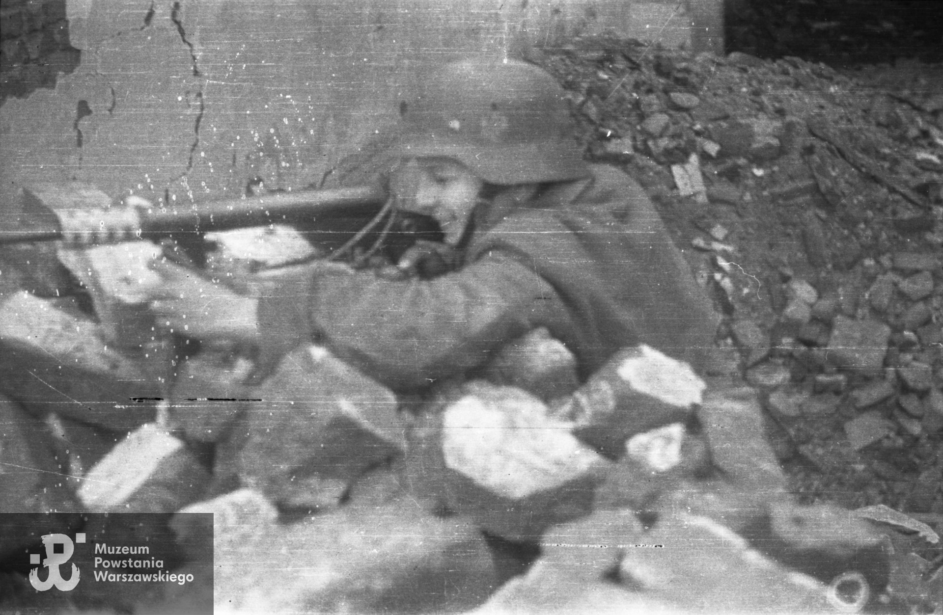 Fotografia z Powstania Warszawskiego. Strz. Tadeusz Rajszczak "Maszynka" z "Batalionu "Miotła" pluton "Torpedy" na terenie między Instytutem Głuchoniemych i Ociemniałych przy placu Trzech Krzyży a Książęcą 7.  Autorem zdjęcia jest Jerzy Michalski "Korczak". Fot. ze zbiorów Muzeum Powstania Warszawskiego, sygn. MPW-IP/2125